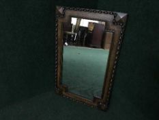 An Edwardian oak framed mirror