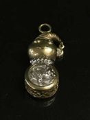 A two-tone snowman pendant stamped 14K.