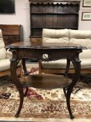 An ornate carved occasional table