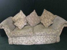 A three piece lounge suite in a beige fabric