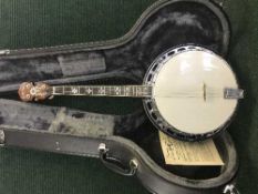 A cased Gold Tone tenor banjo