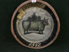 A papier mache bowl depicting a prize bull
