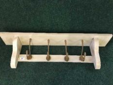 A reclaimed pine four-hook coat rack
