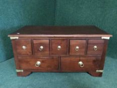 A mahogany brass bound coffee table chest fitted with seven drawers