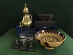 A basket of binoculars, brass kettle, foreign currency,