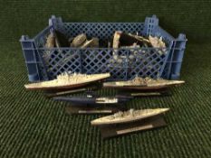Two baskets of battle ships and submarines on stands together with a crate of die cast and other