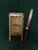 A reproduction propeller wall clock together with a hanging pine corner shelves