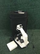 A Bresser Biolux AL microscope with accessories in carry case