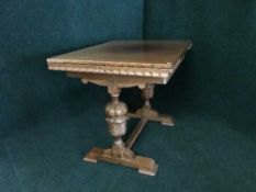 A carved oak pull-out dining table