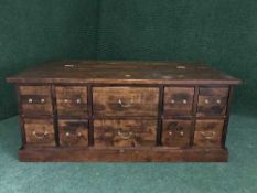 A contemporary hardwood storage coffee table fitted with ten drawers