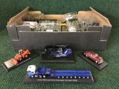 A box of die cast vehicles including fire trucks, police cars,