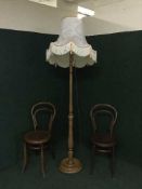 A pair of Bentwood chairs together with a standard lamp and shade