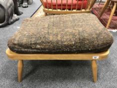 An Ercol light elm footstool