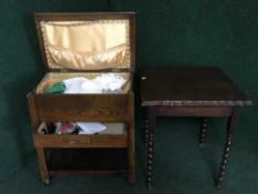 An oak sewing trolley and contents and an oak barley twist occasional table