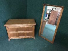 An oak shoe cupboard together with matching hall mirror