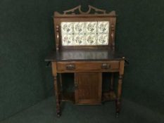 A late Victorian mahogany marble and tiled backed washstand