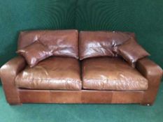 A tan leather two seater settee