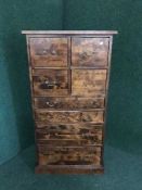 A hardwood multi drawer chest with brass drop handles