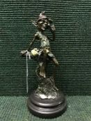 David Goode : A bronze figure of a goblin seated upon a tree stump, on marble base, signed.
