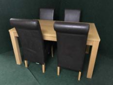 A dining table and four high backed leather chairs