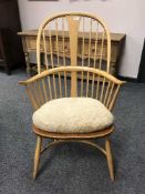 An Ercol light elm spindle backed Windsor style armchair