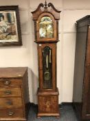 A reproduction regulator clock in inlaid walnut case