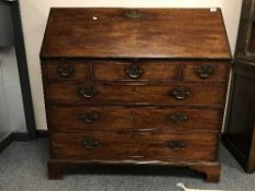 A George III mahogany bureau on bracket feet