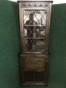 A Jaycee oak glazed corner cabinet