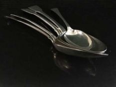 Four silver serving spoons and a silver dessert spoon