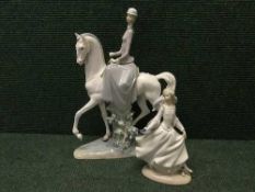 A Lladro figure of a lady riding side-saddle on a white horse,
