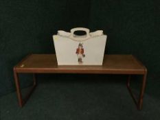 A teak G-plan coffee table together with a cream and gilt magazine rack depicting a fox