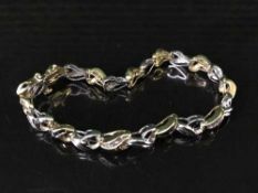 A two-tone gold (tests 18ct) diamond and sapphire set bracelet,
