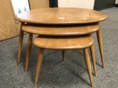 A nest of three Ercol elm pebble tables
