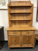 An Ercol light elm kitchen dresser