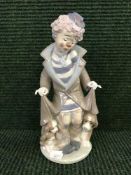 A Lladro figure of a clown with puppies,