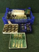 A basket of plated cutlery,