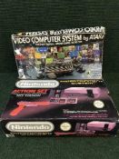 A boxed Nintendo entertainment system with games together with an Atari video computer system