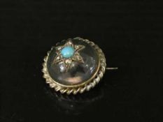 A yellow metal and rock crystal brooch set with diamonds and turquoise