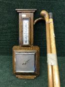 An early 20th century barometer and bundle of three walking sticks