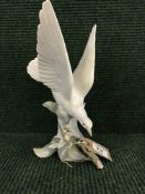 A Lladro figure of a turtle dove on branch