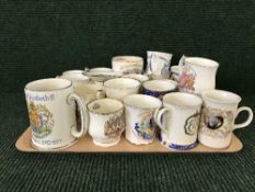 A tray of commemorative ware mugs