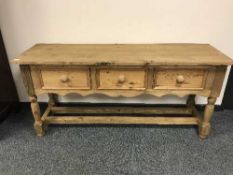 A reclaimed pine three drawer hall table fitted with three drawers
