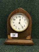 An inlaid mahogany arched topped mantel clock