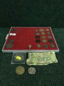 A coin case containing crowns, silver dollars, British currency,