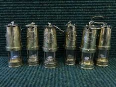Set of six miniature brass miner's lamp bearing City of Durham label