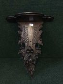 A late 19th century heavily carved mahogany wall bracket