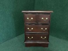 A mahogany three drawer chest with brass drop handles