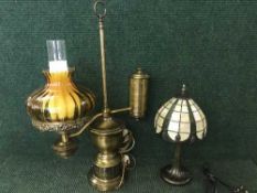 A metal table lamp in the form of an oil lamp,