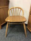 An Ercol light elm small dressing table chair