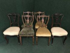 A set of four inlaid mahogany Regency style shield back dining chairs with velvet seats,